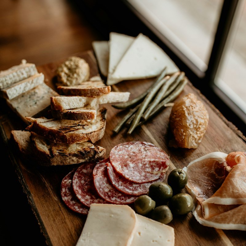 Charcuterie board with salami, bread and olives