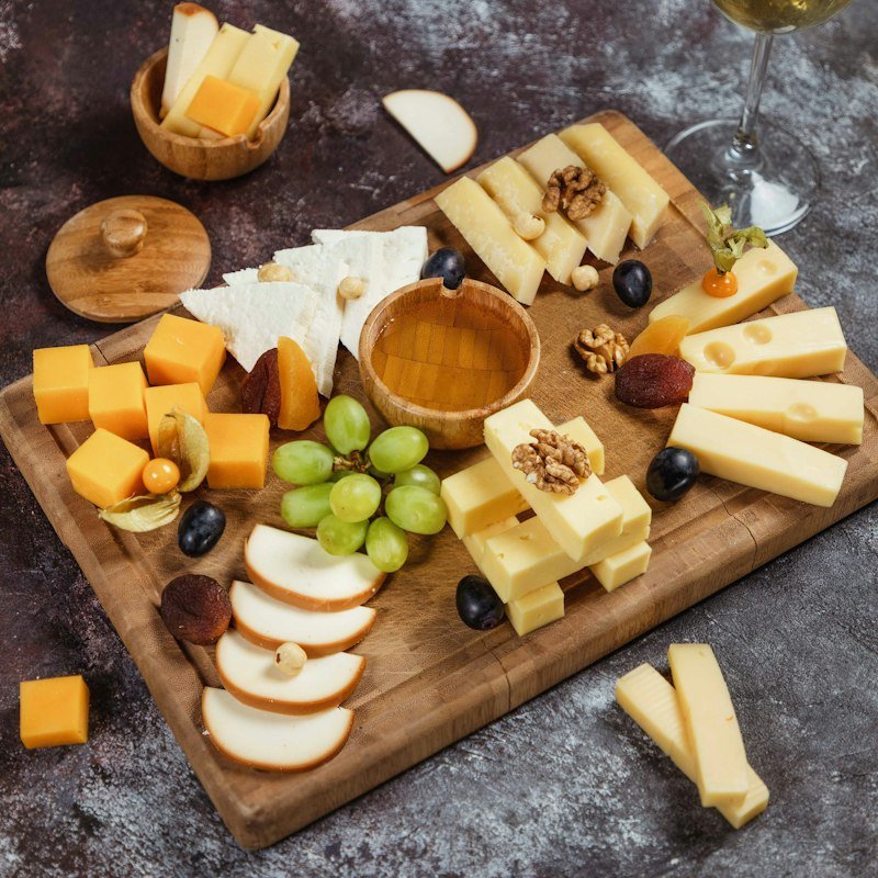 Cheese board with grapes, nuts and cubed cheeses