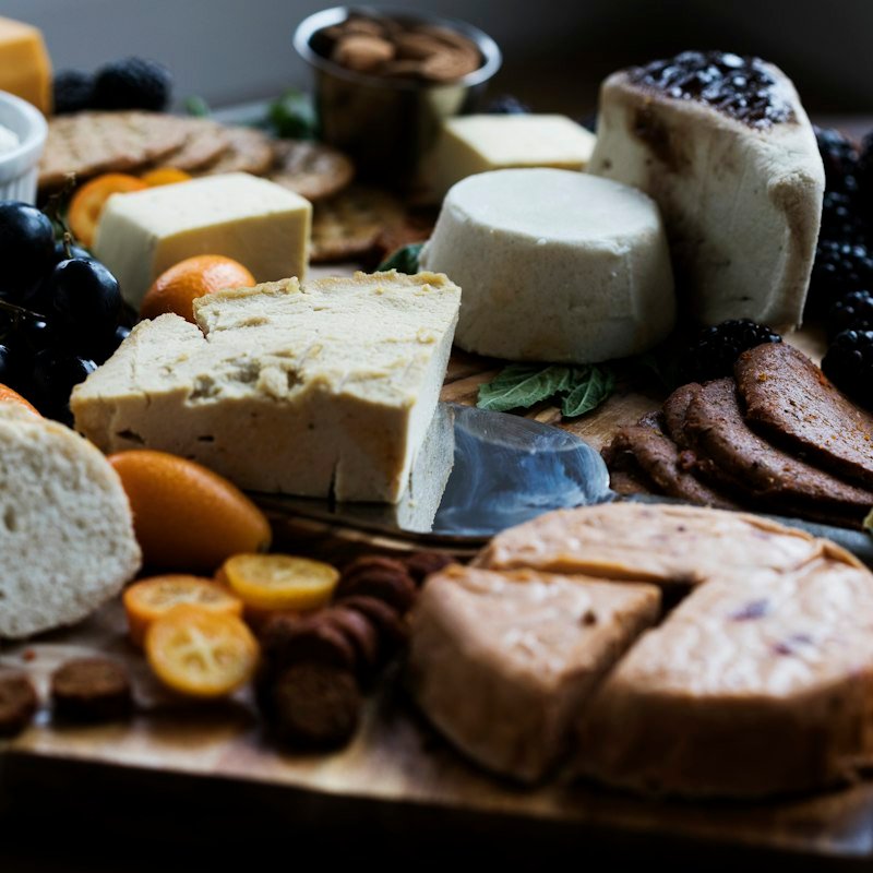 Artisan cheese display with berries and bread