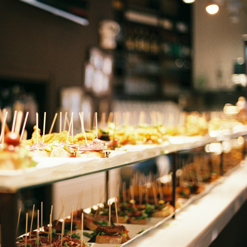 Hors d’oeuvres display with rows of skewered canapés