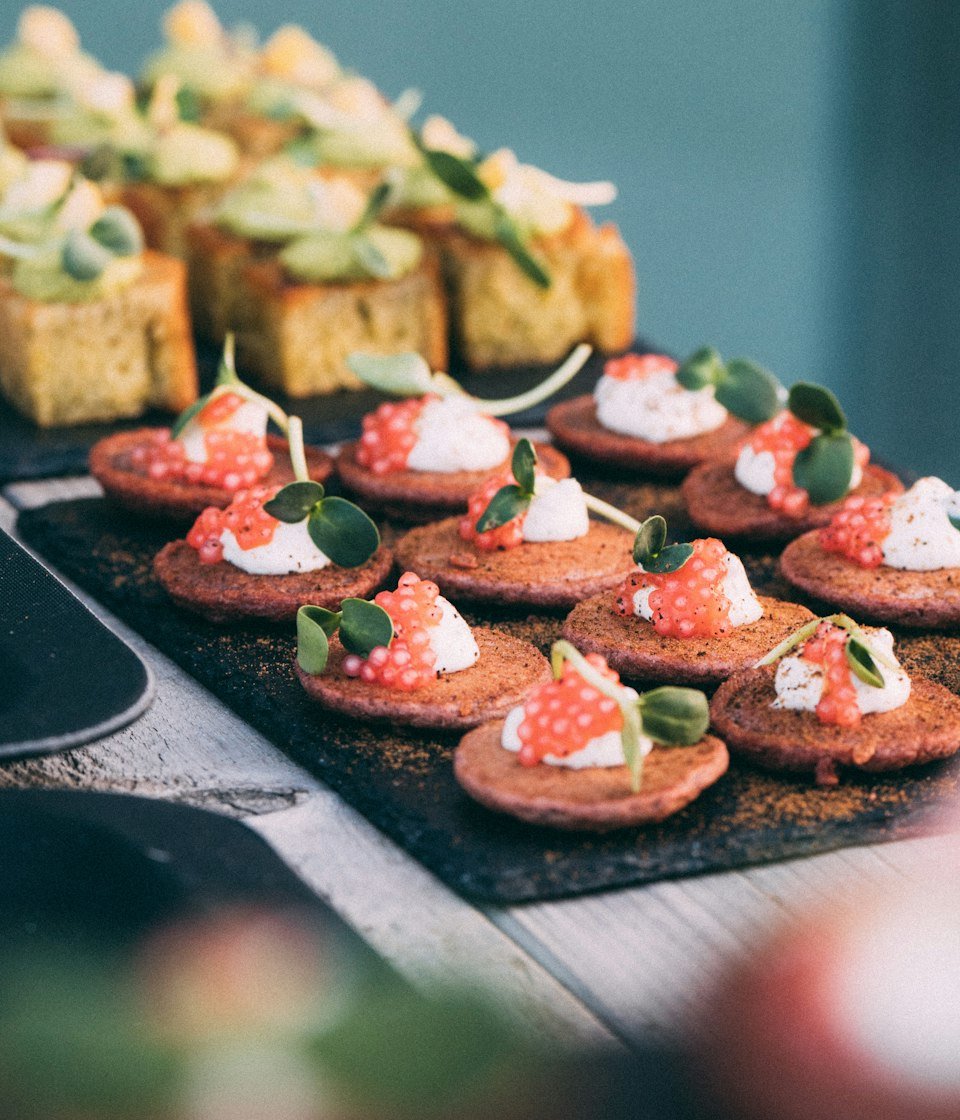 Canapés topped with whipped cheese and fresh herbs